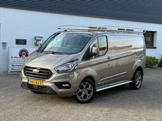 Ford Transit Custom GB 2.0 TDCi 170PK 320 L2H1 Limited/ 18 Inch/ RVS Imperiaal/ Sidebars/ Vloer + wand platen/ Stoelverwarming/ Trekhaak/ Apple Carplay/ Zeer nette bus